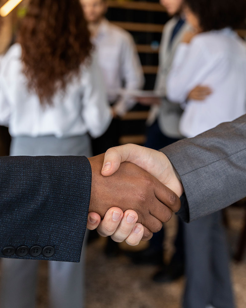 Close up image of two people shaking hands.